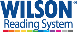 Logo of the Wilson Reading System. The word WILSON is in large blue capital letters, with a registered trademark symbol. Below it, in smaller blue letters, reads Reading System. A strip of seven colored boxes in various colors is beneath the text.