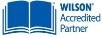 Logo of "Wilson Accredited Partner" featuring an open book icon in blue next to the text.